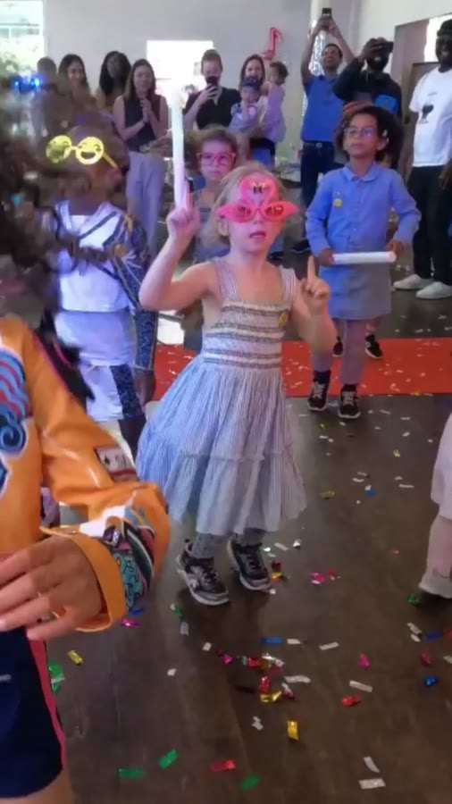 A kid in the spotlight on the dance floor